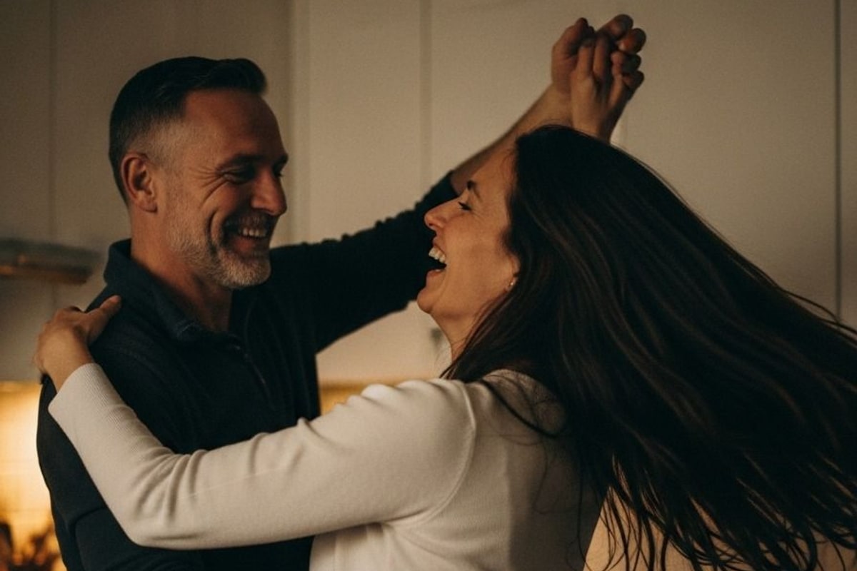 A couple dancing and laughing together in a kitchen